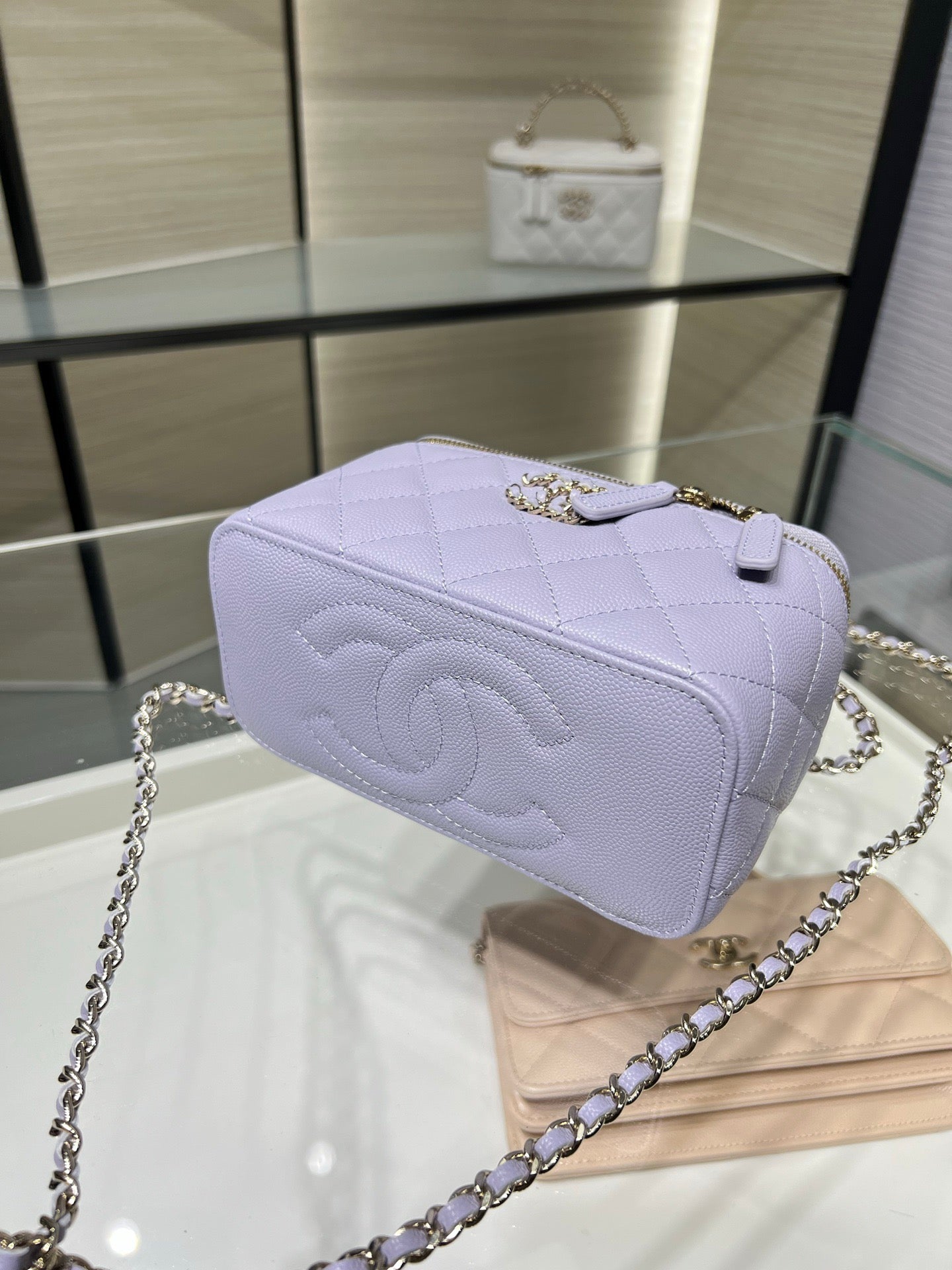 Chanel quilted shoulder bag in lavender with logo emblem and chain strap, front view