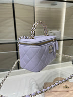 Chanel quilted mini bag in lavender with chain strap, top handle, and gold zipper pull