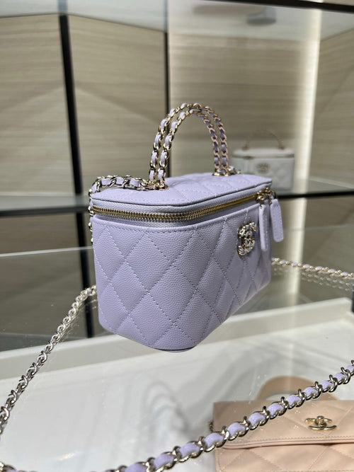 Chanel quilted mini bag in lavender with chain strap, top handle, and gold zipper pull