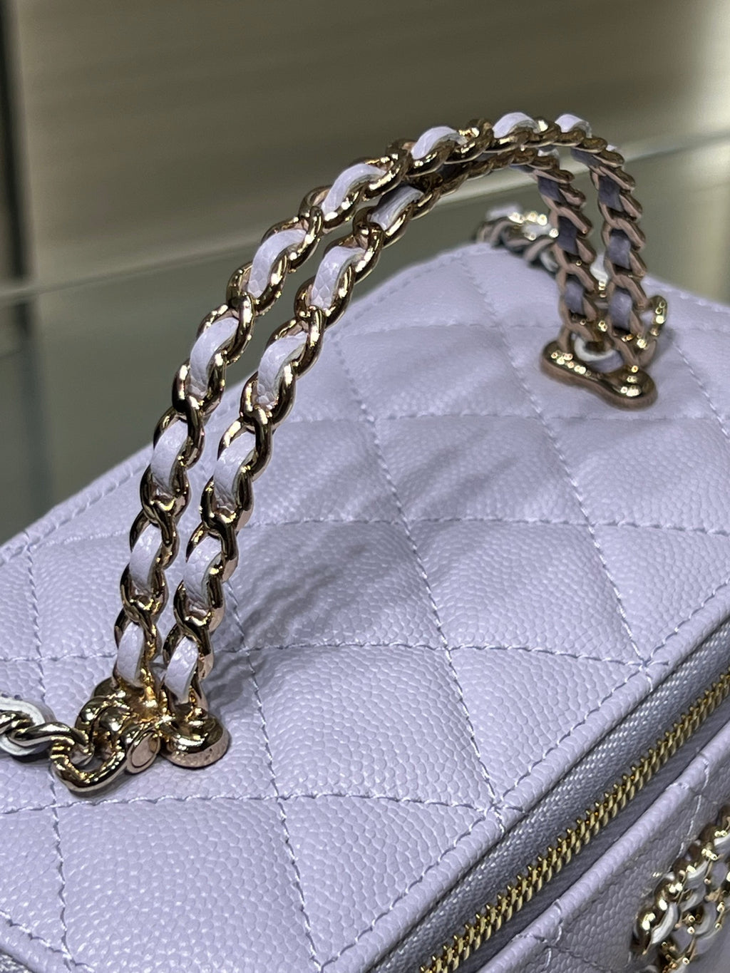 Chanel quilted mini bag in lavender with chain strap and gold-trimmed zipper edge