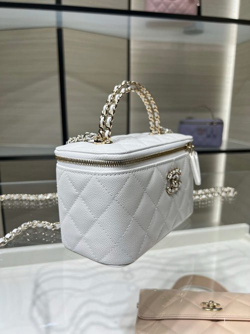 Chanel mini bag in white leather with quilted pattern, chain strap, and zipper top.