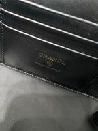 Chanel leather bag close-up with CHANEL branding and 'Made in Italy' stamp.
