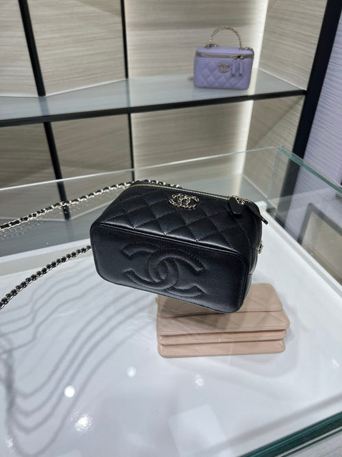 Chanel mini crossbody bag with quilted finish, chain strap, and gold logo emblem.
