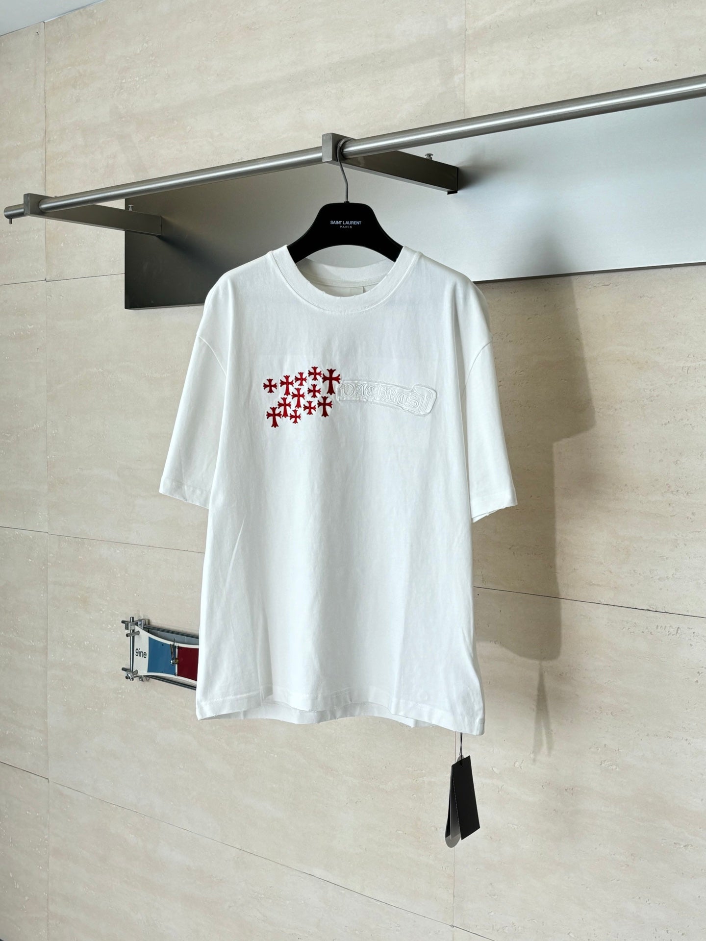 White short-sleeve T-shirt with chest pocket and red and blue logo print