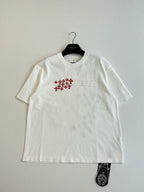 White short-sleeve T-shirt with small chest red logo and text detail