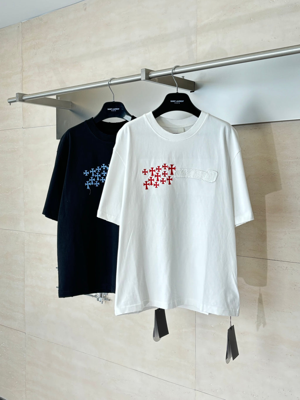 Short-sleeve graphic T-shirts in black and white, both with logo print