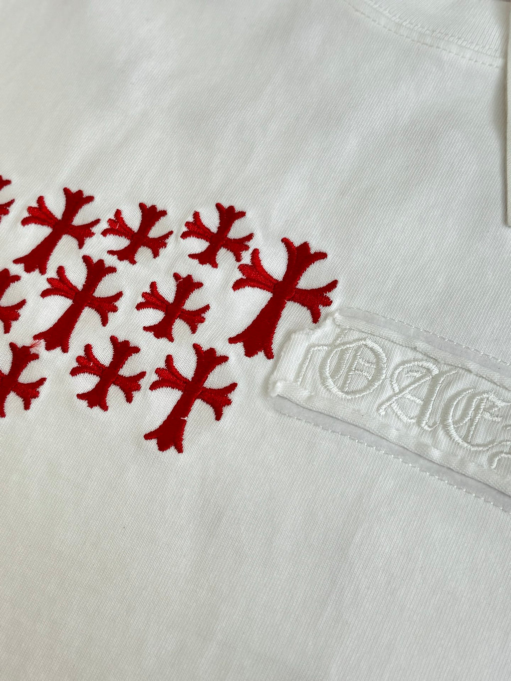 White T-shirt close-up with red logo graphic and embossed logo tab
