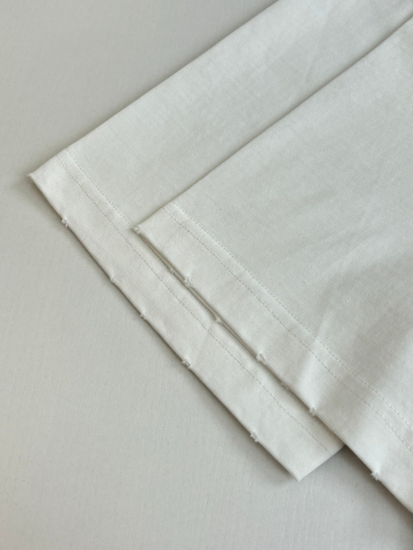 White T-shirt folded cuffs and hem with double-stitched edge