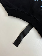 Black short-sleeve T-shirt sleeve cuff and folded hem detail