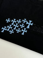 Close-up of black T-shirt fabric with blue snowflake logo
