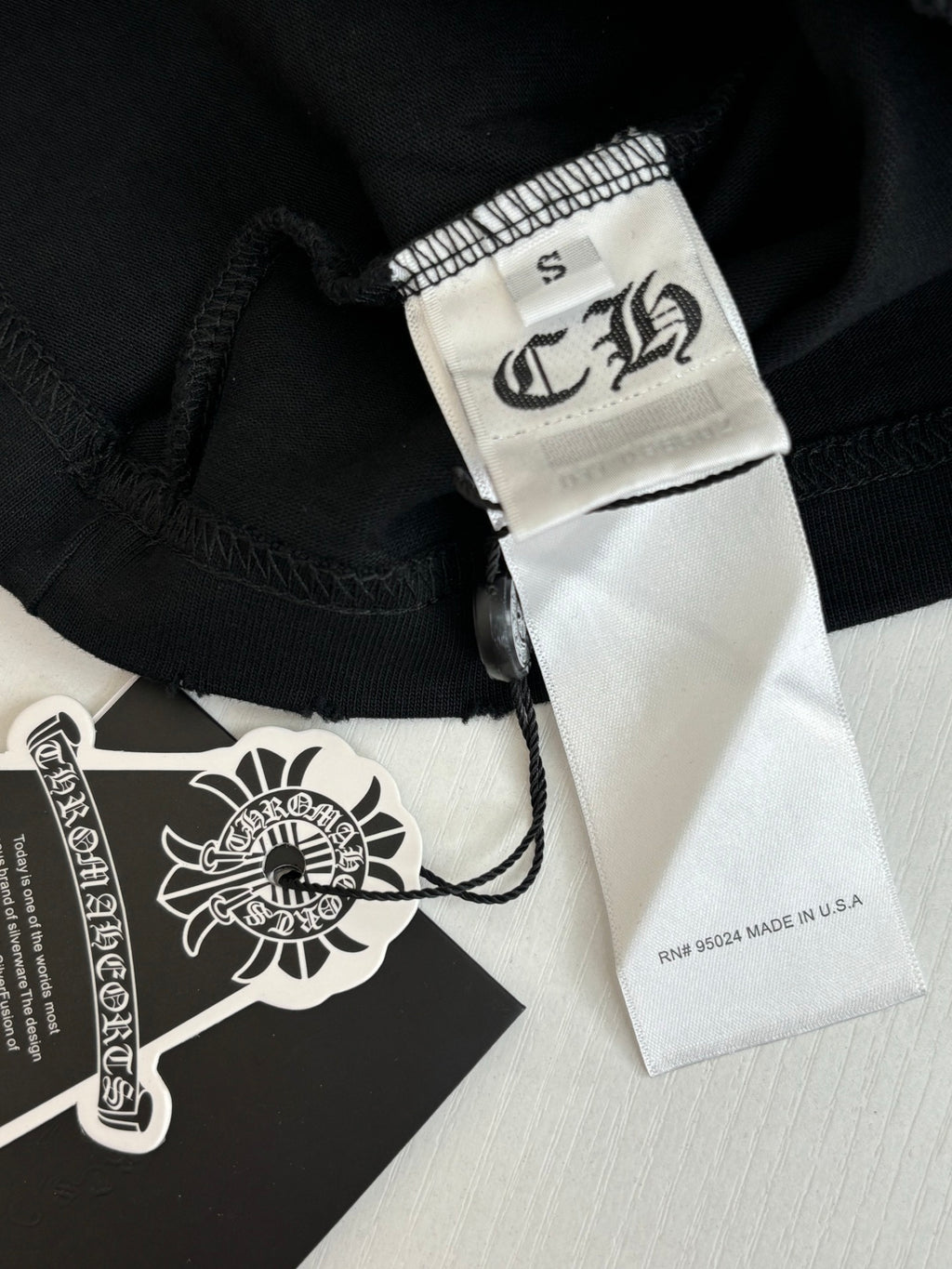 Black fabric shorts with sewn brand label and size tag at hem