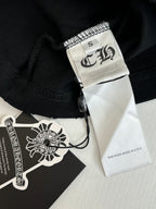 Black fabric shorts with sewn brand label and size tag at hem