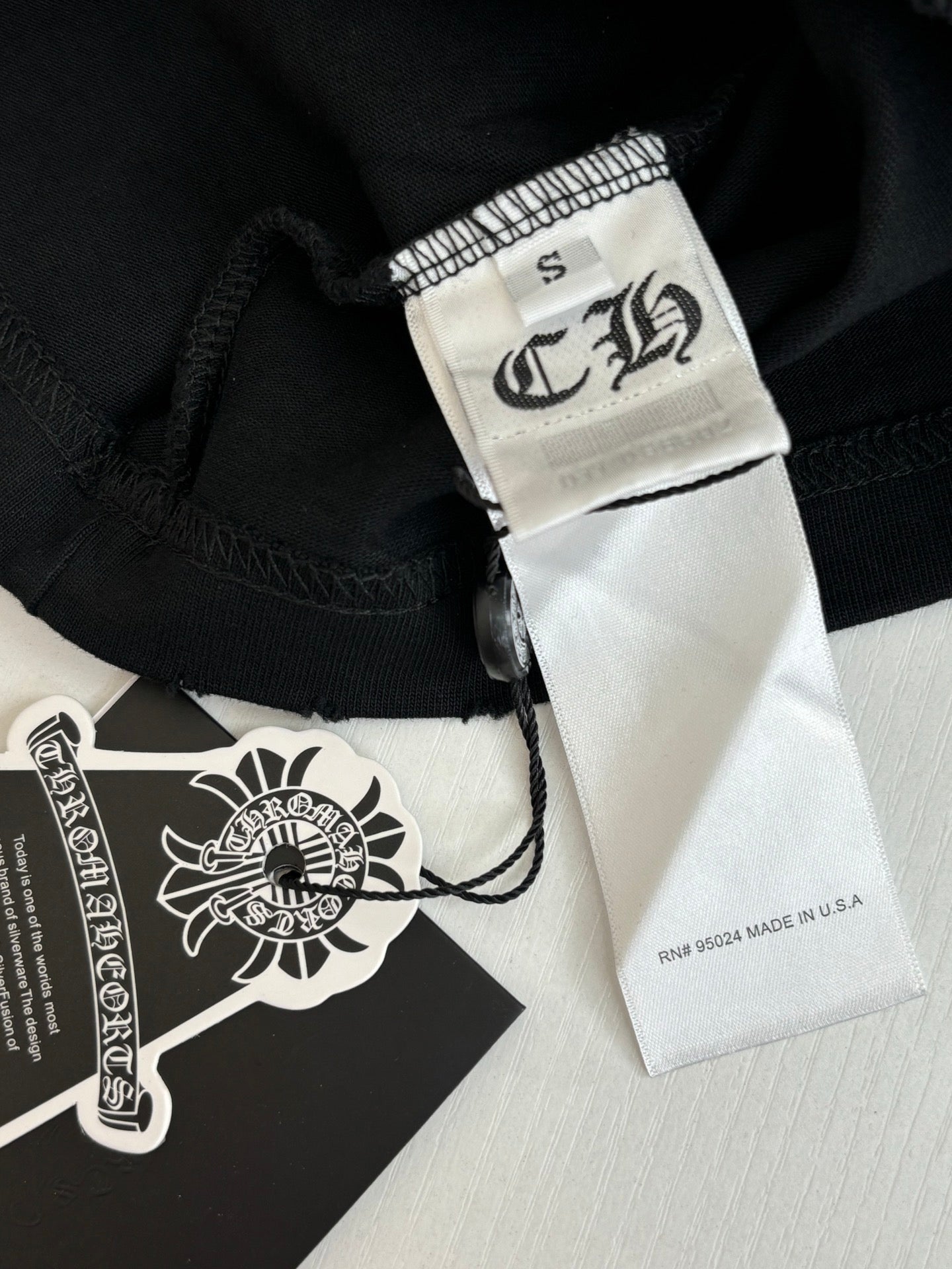 Black fabric shorts with sewn brand label and size tag at hem