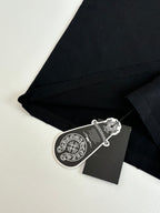Black T-shirt corner with stitched seam and hanging hangtag