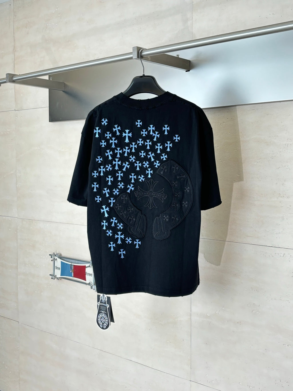 Black short-sleeve T-shirt with blue snowflake pattern and large chest emblem