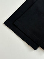 Folded black short-sleeve T-shirts stacked together