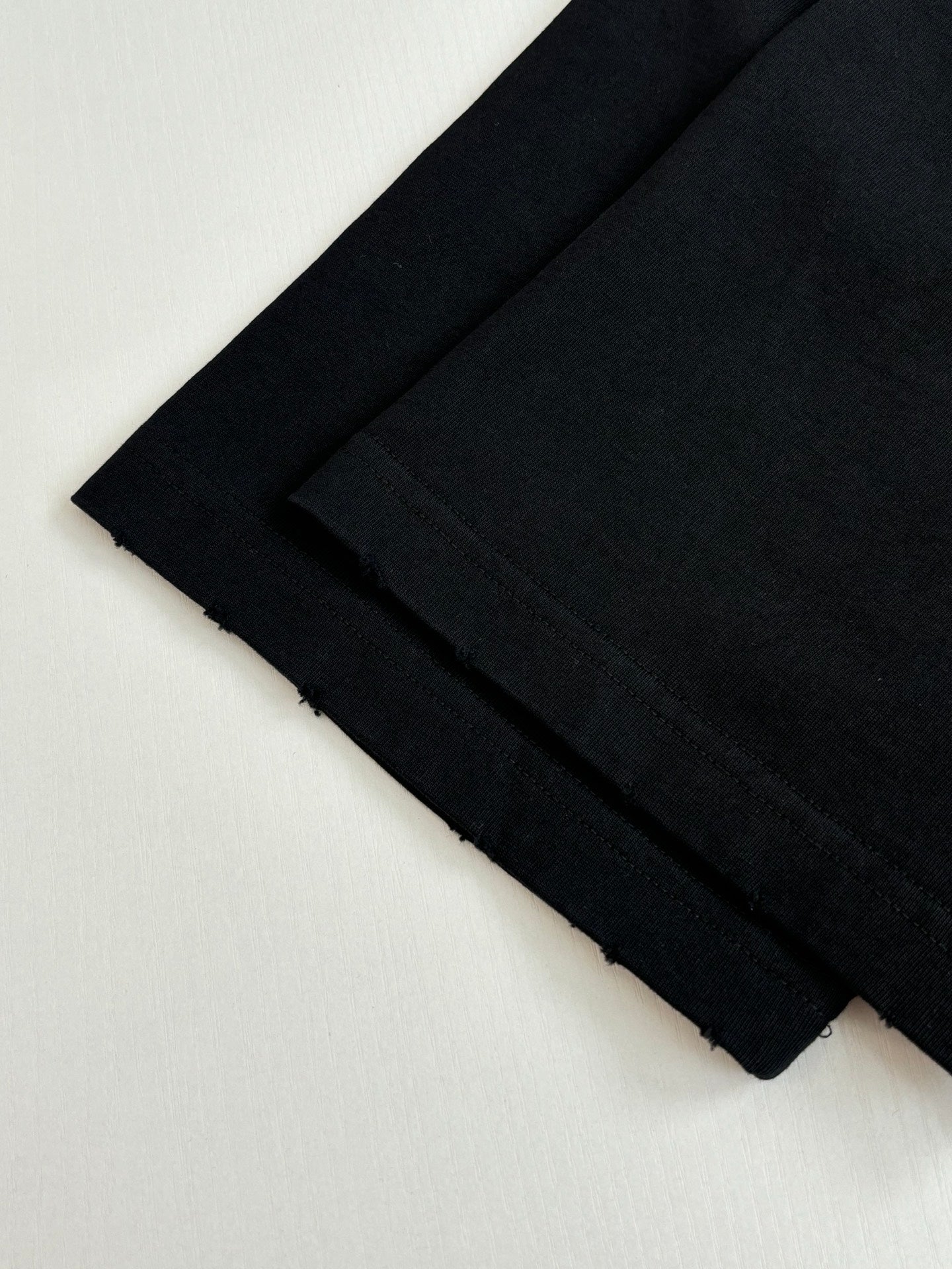 Folded black short-sleeve T-shirts stacked together