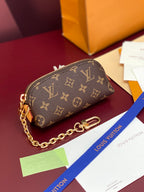 Louis Vuitton monogram wristlet pouch with gold chain strap, side view