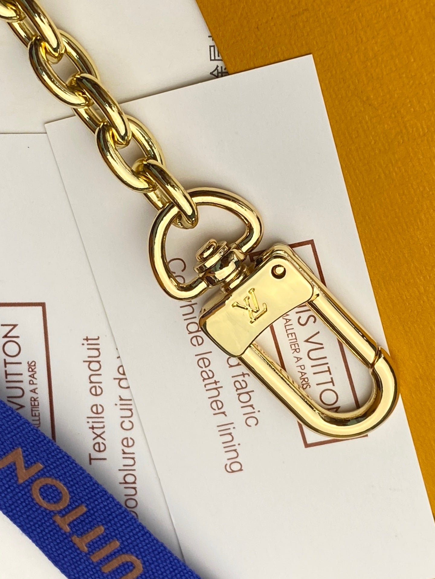 Gold lobster clasp and key ring on monogram pouch chain