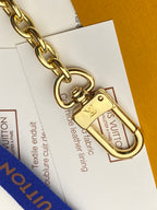 Louis Vuitton gold clasp and chain detail for wristlet pouch