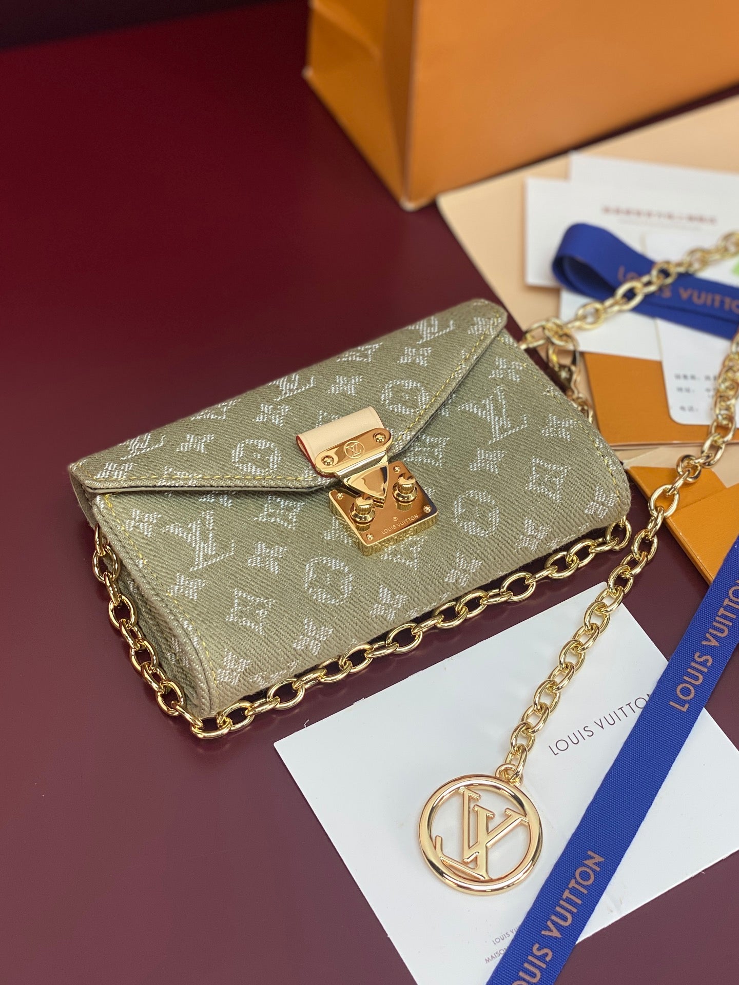 Monogram flap crossbody bag in sage canvas with gold-tone lock and long chain strap