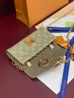 Gray-green monogram mini handbag with gold chain strap, front flap and logo charm