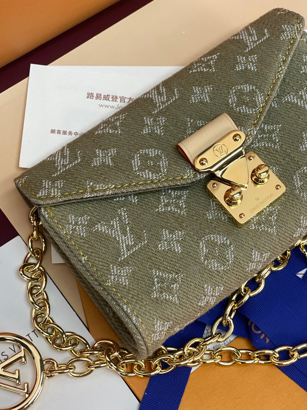 Monogram flap crossbody bag in sage canvas with gold-tone clasp and chain strap