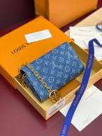 Blue monogram canvas mini bag with gold chain strap and front flap clasp