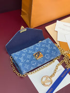Blue monogram flap crossbody bag with gold chain strap and logo charm
