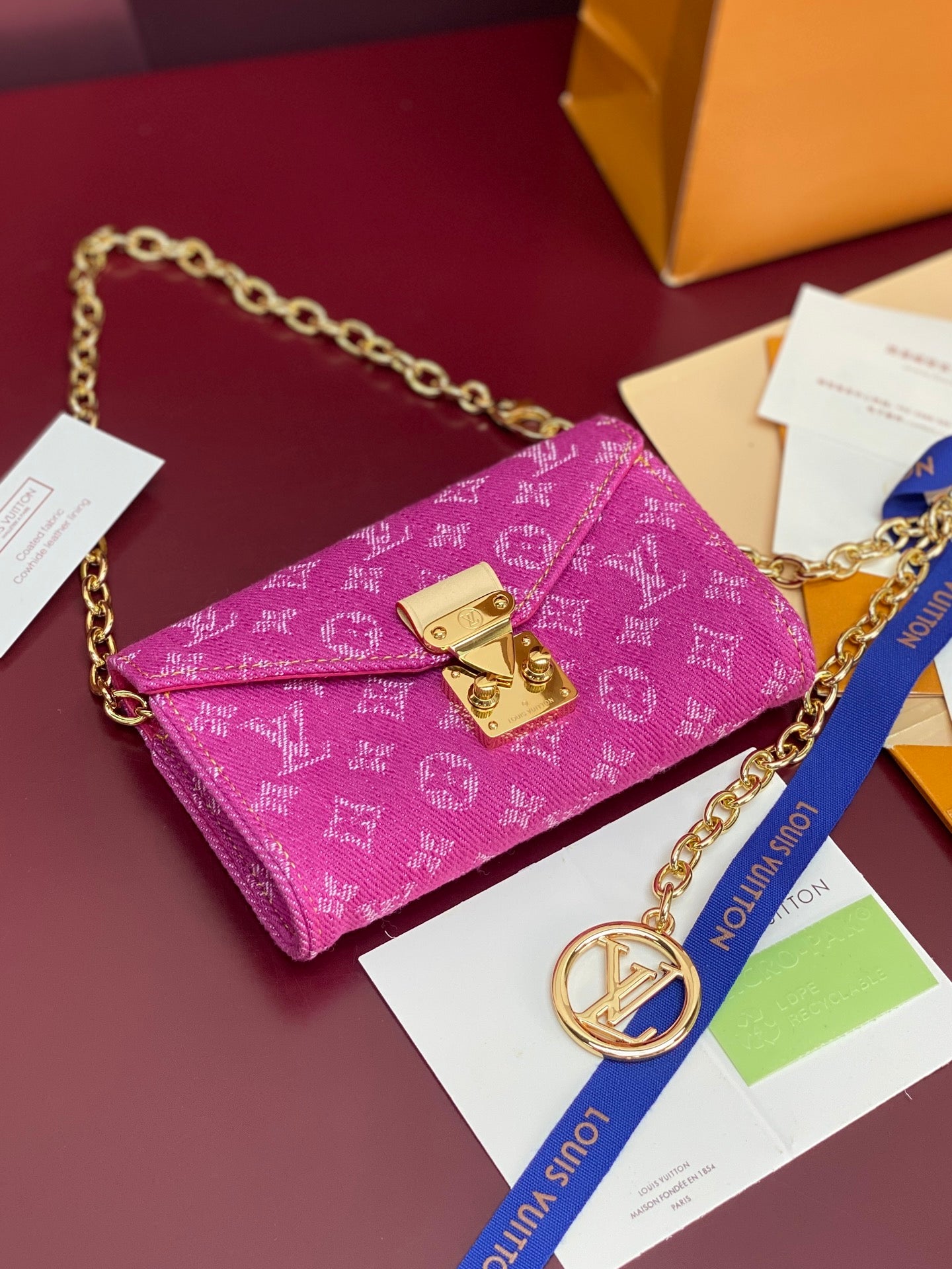 Purple monogram mini flap crossbody bag with gold buckles and chain strap