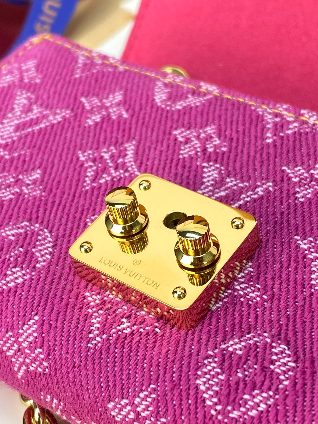 Small bag gold snap buttons on purple patterned fabric flap