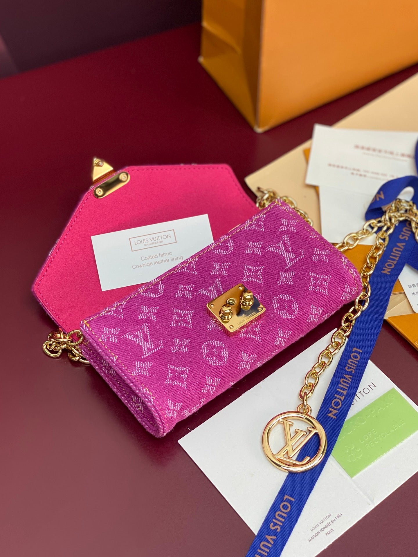 Pink monogram mini flap crossbody bag with gold chain strap and clasp
