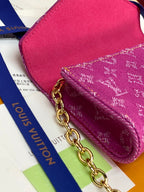 Pink textured mini bag with monogram pattern and gold chain clasp detail