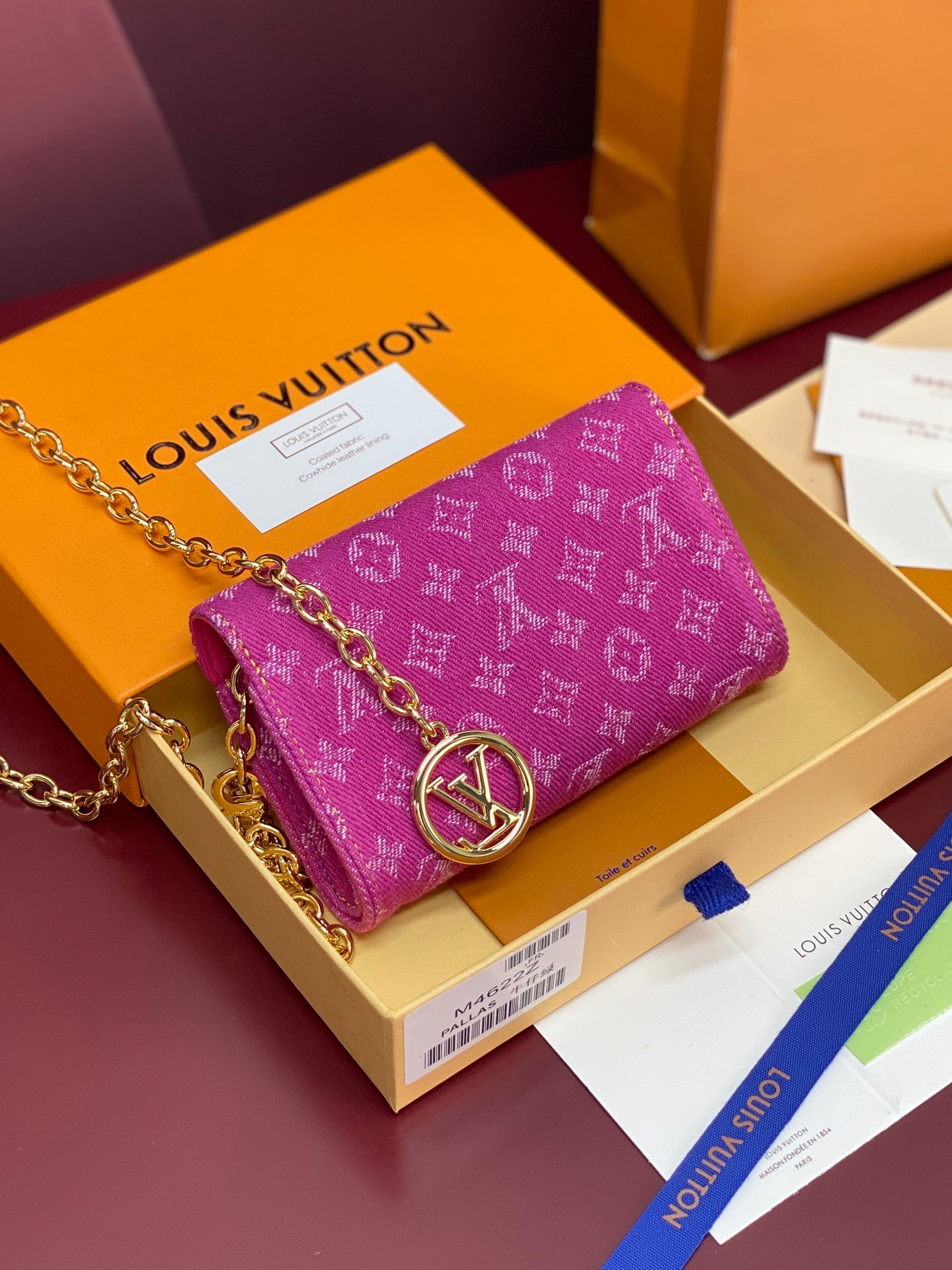 Purple monogram mini flap bag with front emblem clasp and gold chain