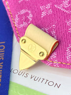 Louis Vuitton small bag close-up of gold stud and corner hardware on pink monogram canvas