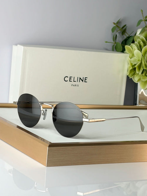Celine round glasses with gold metal frame and dark lenses, angled front