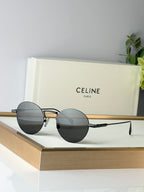 Celine round glasses with gold metal frame and dark lenses, front view