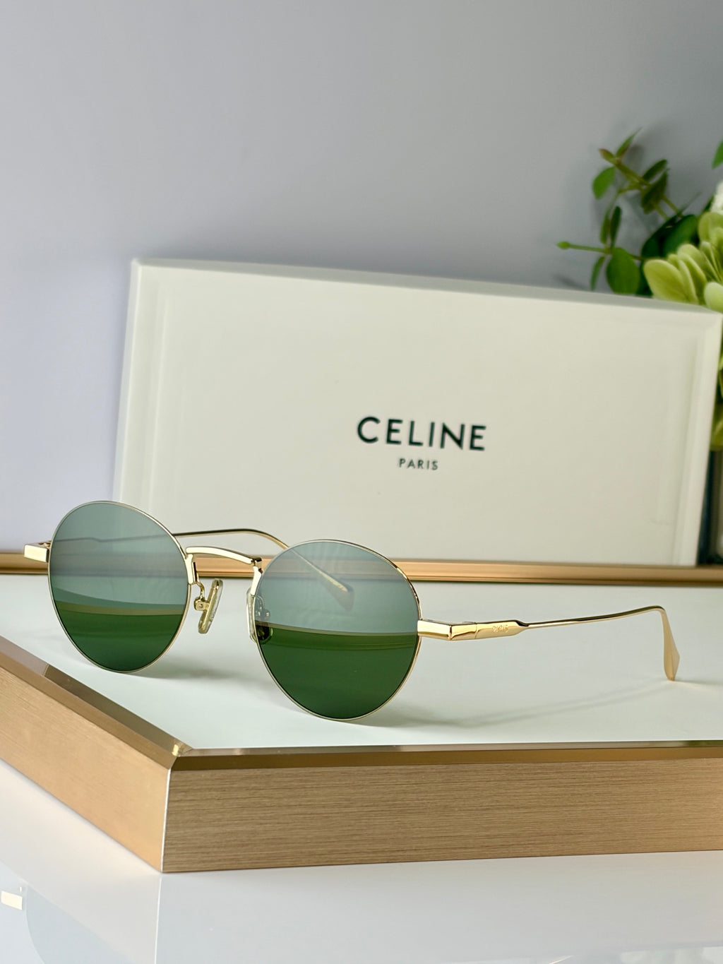 Celine round glasses with gold metal frame and green-tinted lenses