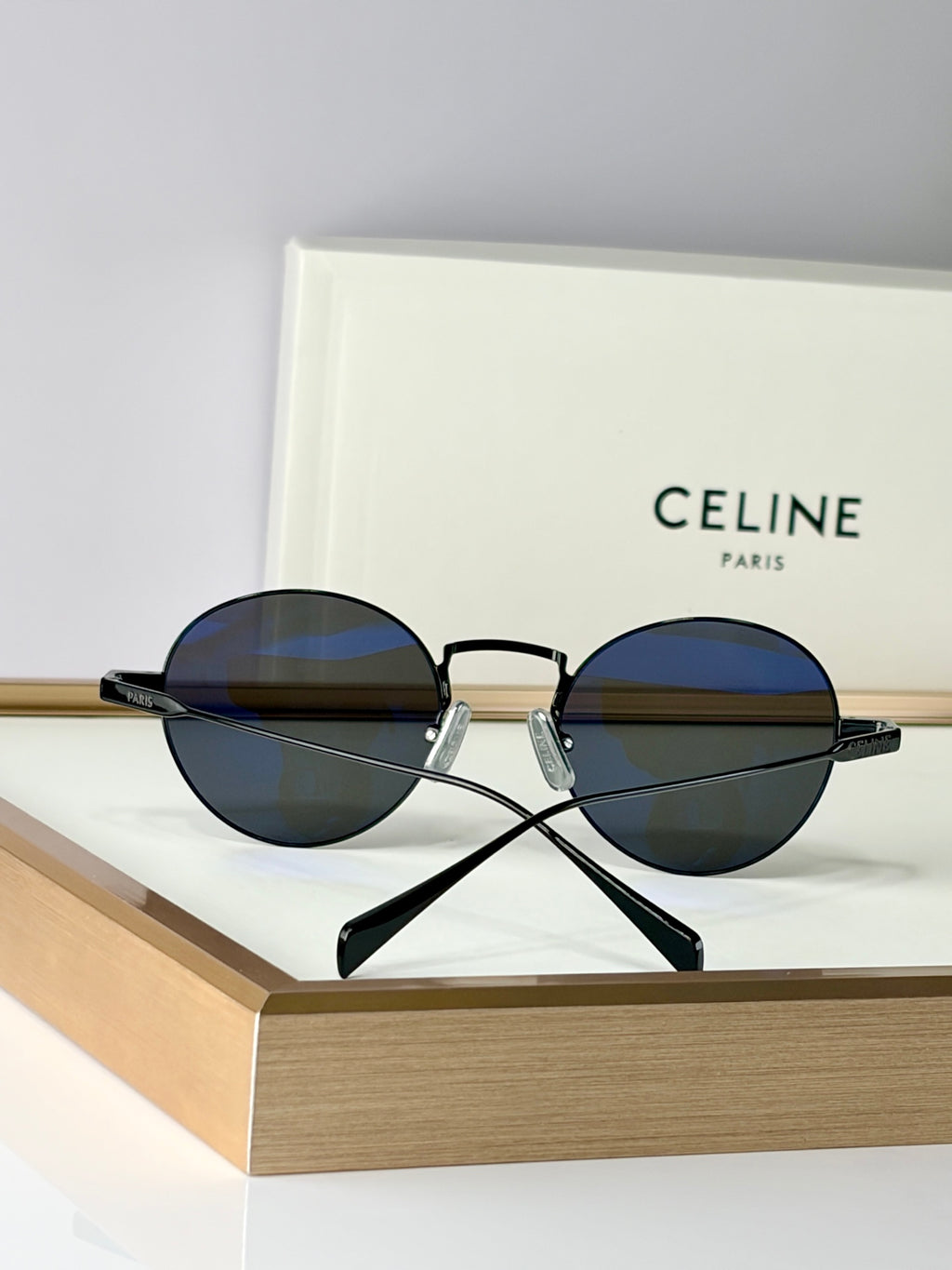 Round sunglasses with black frames and dark lenses, front view