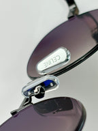 Sunglasses with purple lenses and metal hinge detail