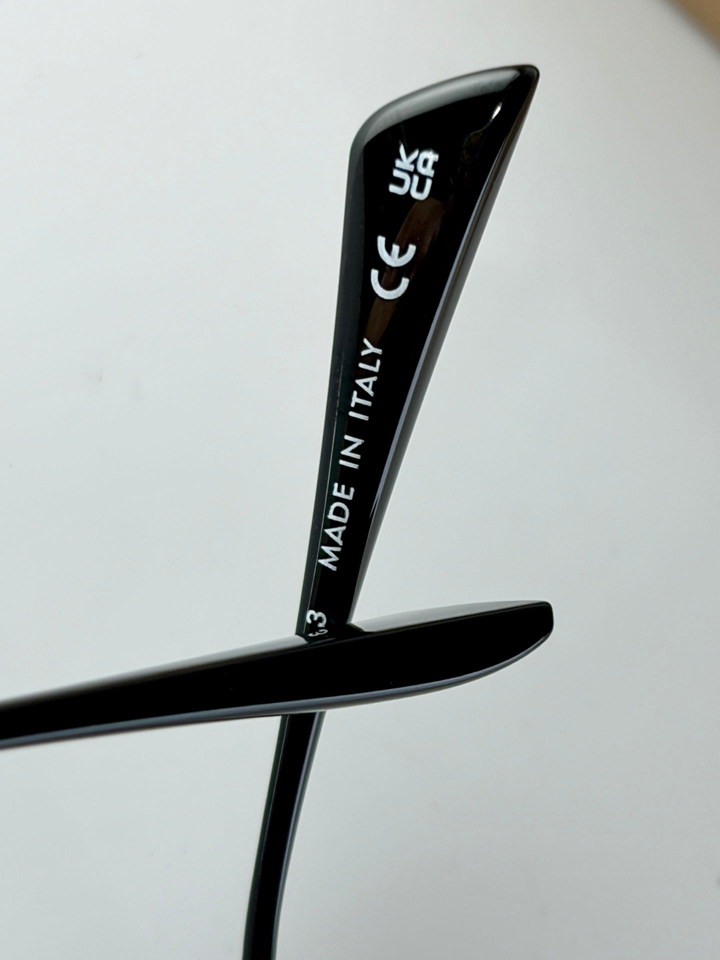 Black sunglasses temple with "MADE IN ITALY" text