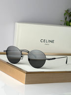 Round sunglasses with black frames and dark gray lenses