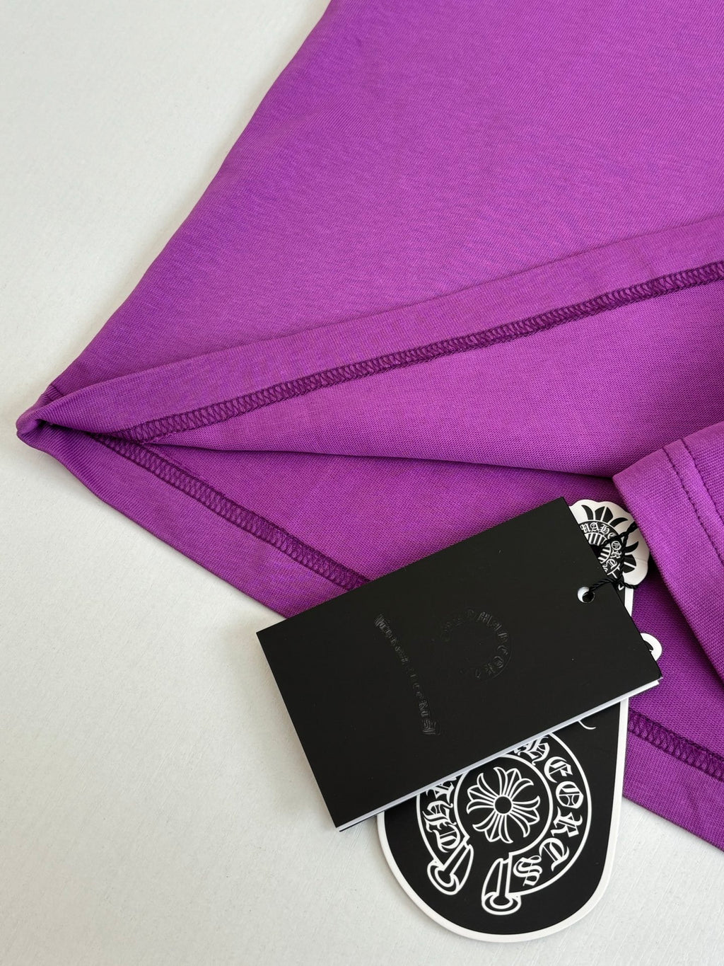 Chrome short-sleeve T-shirt, purple with stitched hem and attached black hang tag