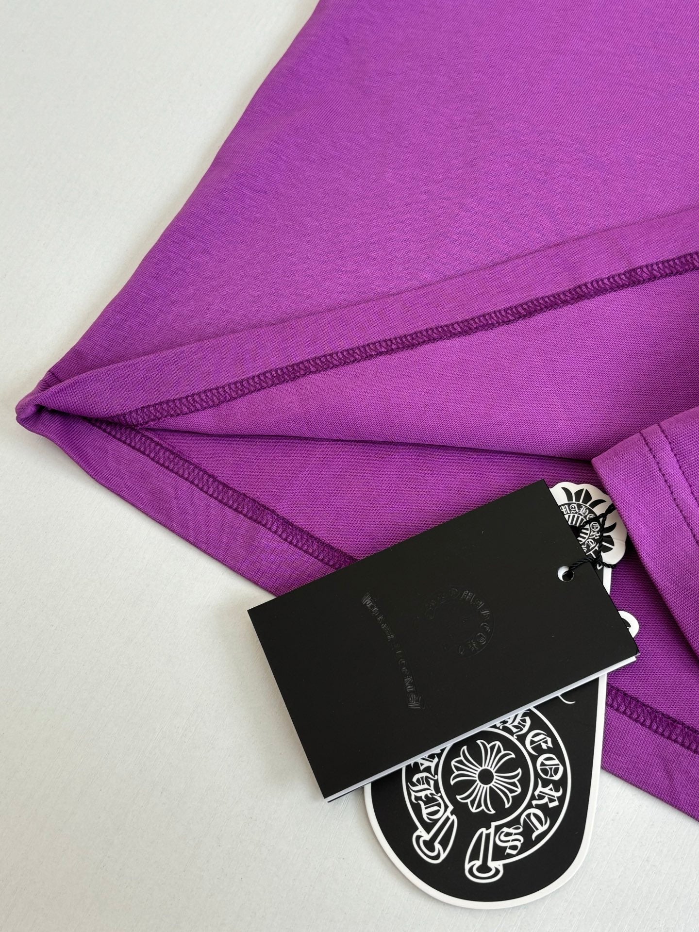 Chrome short-sleeve T-shirt, purple with stitched hem and attached black hang tag