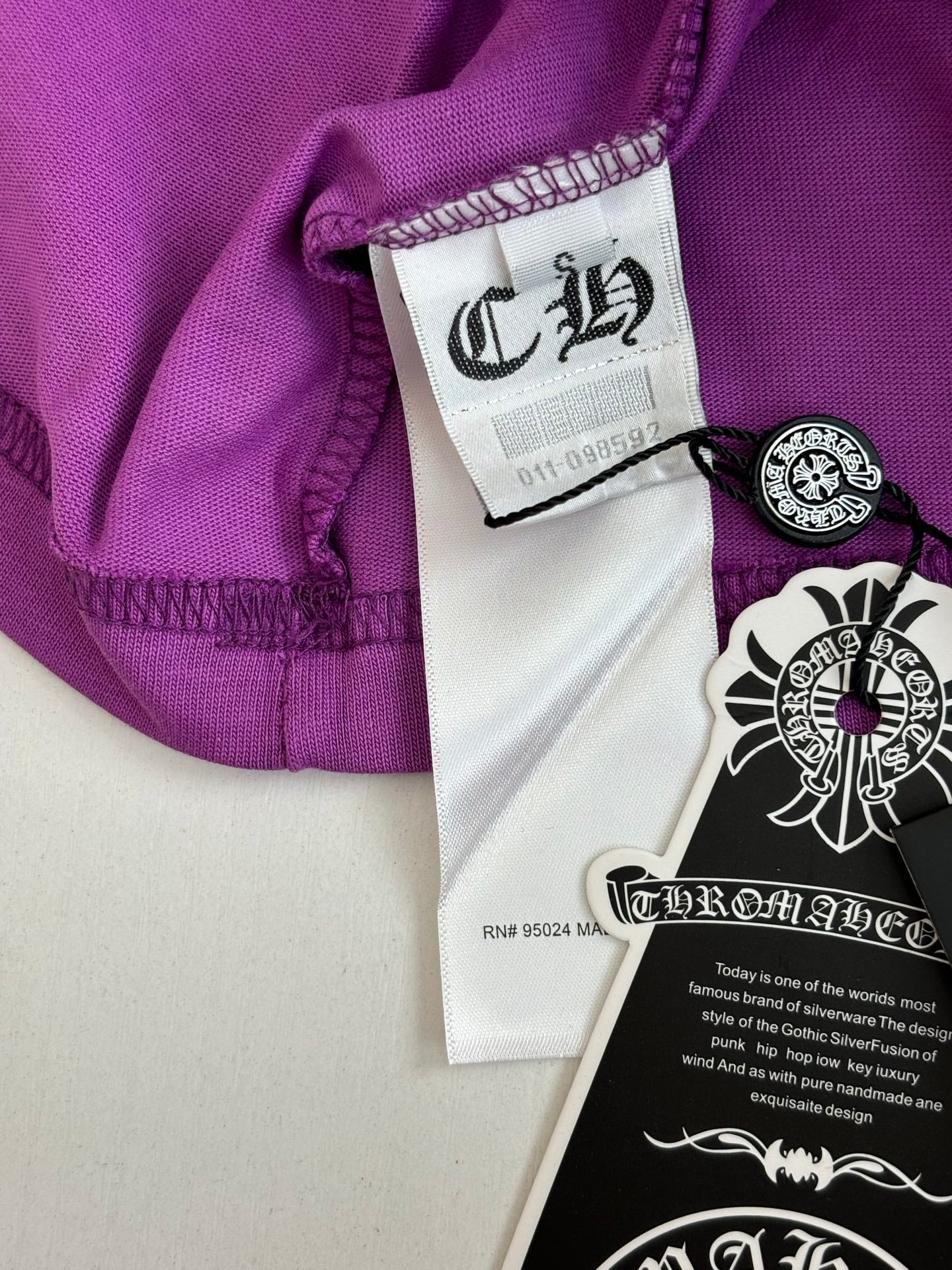 Chrome short-sleeve T-shirt collar area, purple with white size label and black crest tag