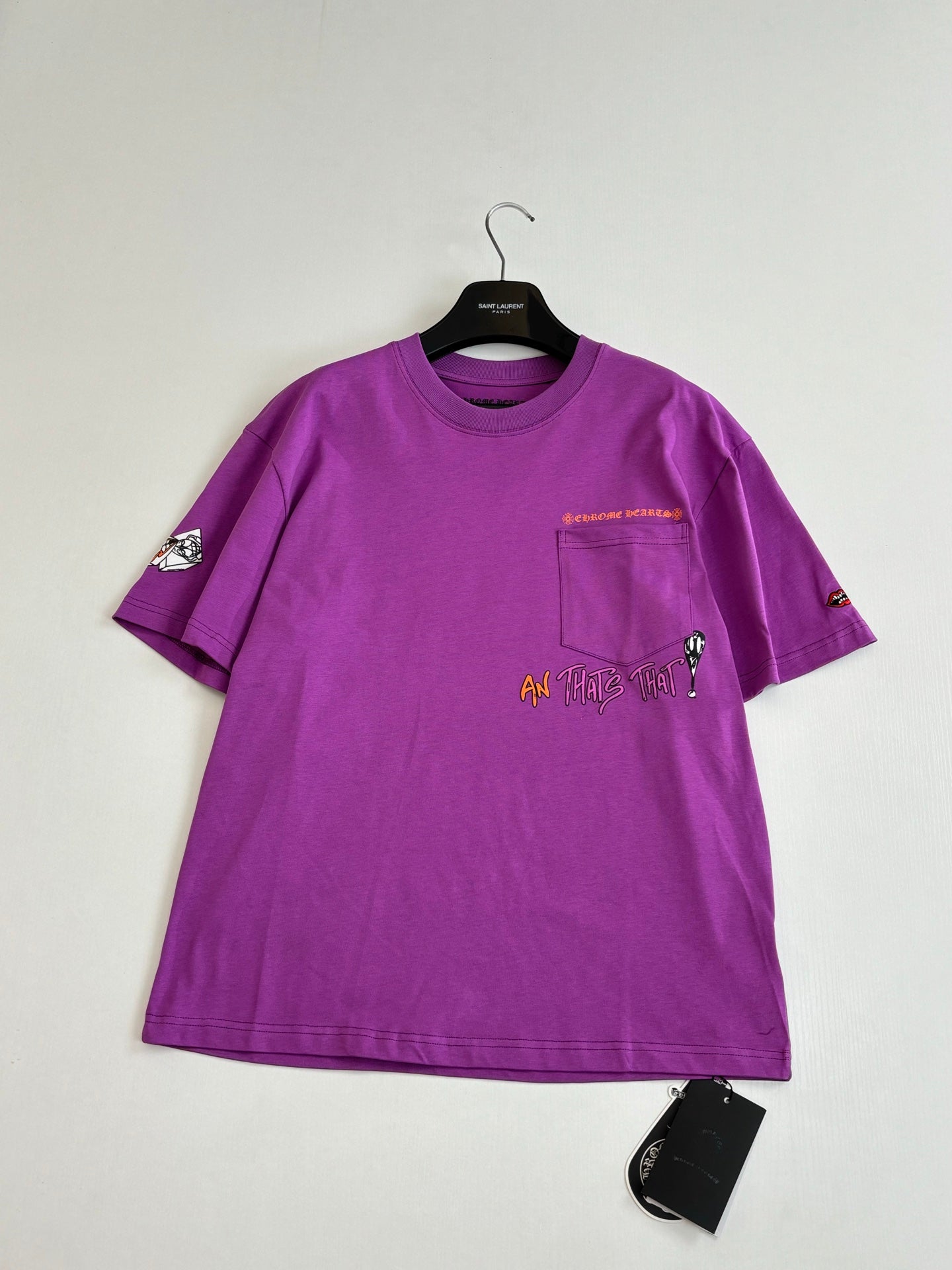 Chrome short-sleeve T-shirt, purple with front chest graphic, laid on hanger