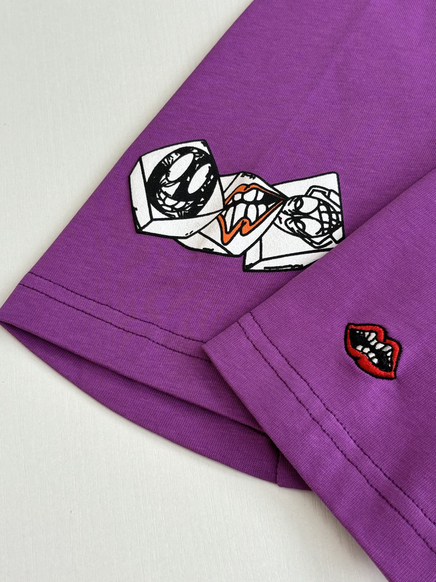 Chrome short-sleeve T-shirt, purple with embroidered sleeve patches near cuff