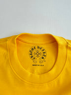 Yellow T-shirt crew neck label with round crest and “Made in U.S.A.” text