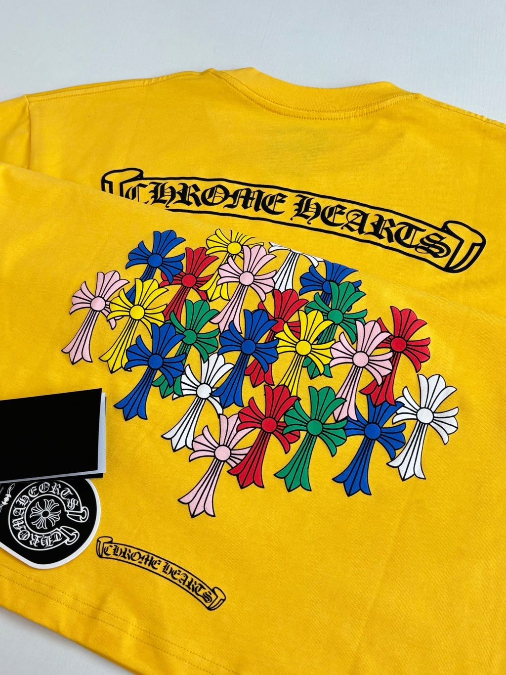 Yellow T-shirt back with colorful floral bouquet graphic and logo