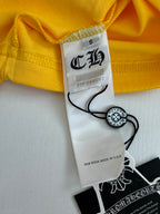 Yellow T-shirt neckline with size label “S” and “Made in U.S.A.” tag